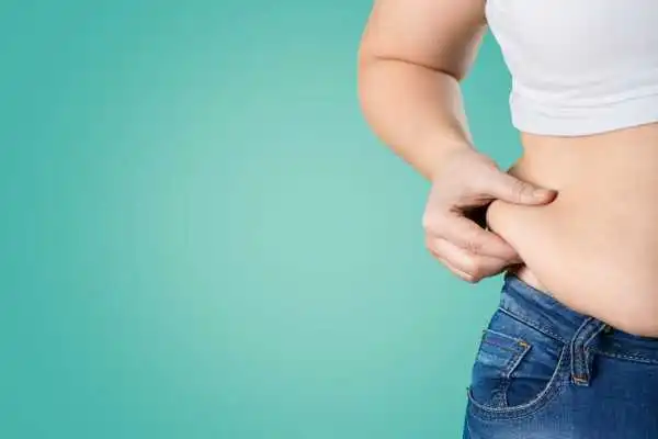 Image of woman pinching her love handles to show weight gain Ledbury