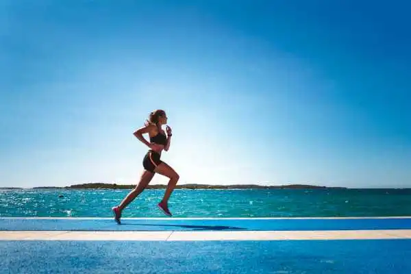 Woman running showing strong leg muscle Ledbury